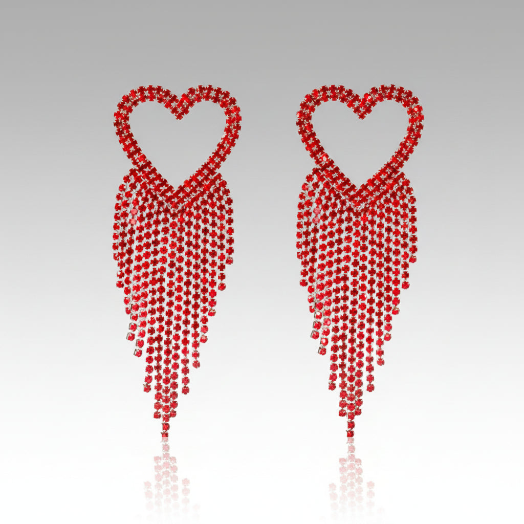A pair of red heart-shaped tassel earrings with silver accents, designed for glamorous occasions.
