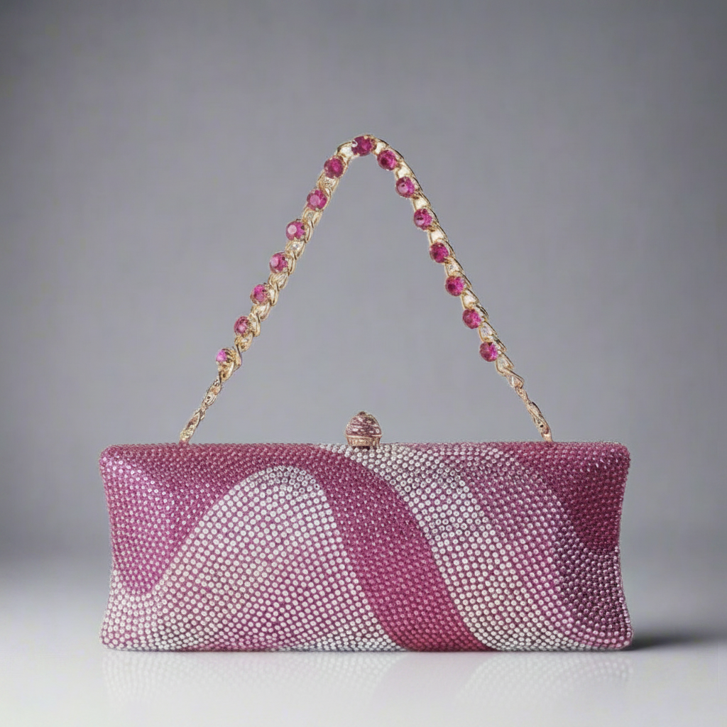 A gold evening bag embellished with pink rhinestones, featuring a clutch style with a latch closure and a detachable chain.