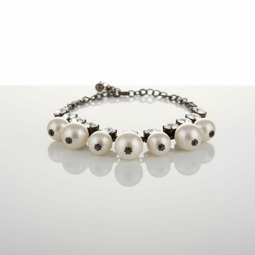 A vintage inspired bronze tone necklace with clear rhinestones and white faux pearls, featuring a lobster claw clasp.