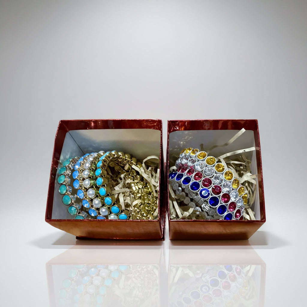 Two open jewelry boxes with decorative bracelets inside on a light gray background