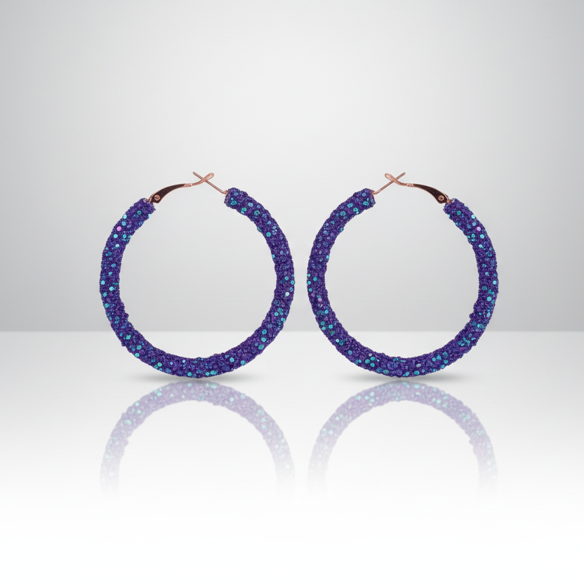 A pair of dark purple rhinestone chip and sequin hoop earrings with gold-tone hooks.