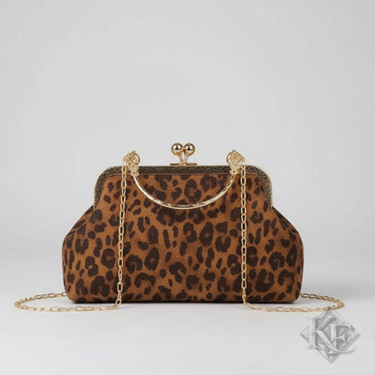 Leopard print handbag with gold chain and frame on a light gray background