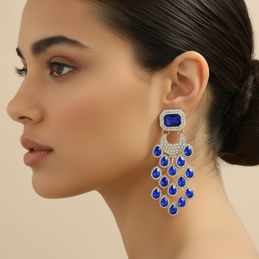 Woman wearing a blue gemstone earring on a beige background