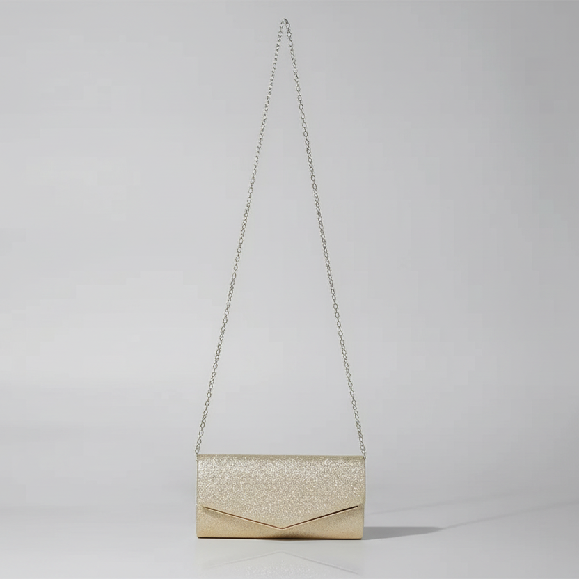 Gold glitter clutch bag with a chain strap on a light gray background