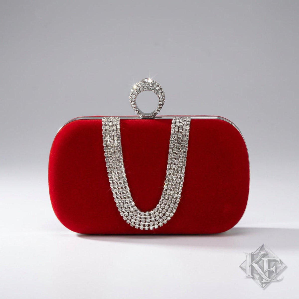 Red clutch bag with silver embellishments on a white background