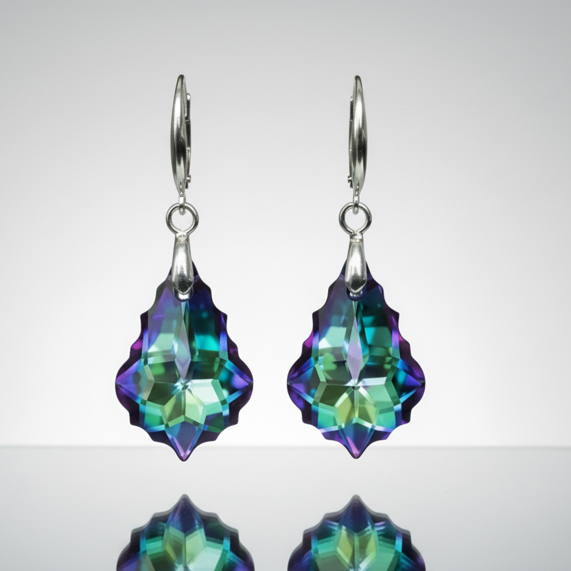 Pair of earrings with multicolored gemstones on a reflective surface.