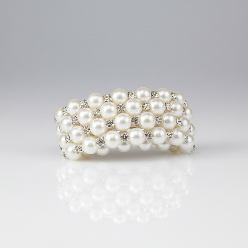 Pearl bracelet with silver accents on a gray background