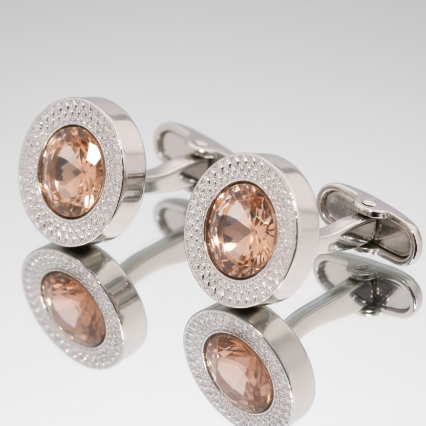 Silver cufflinks with brown gemstones on a white background