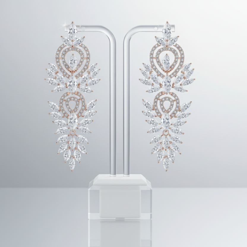 Pair of ornate earrings on a stand against a light gray background