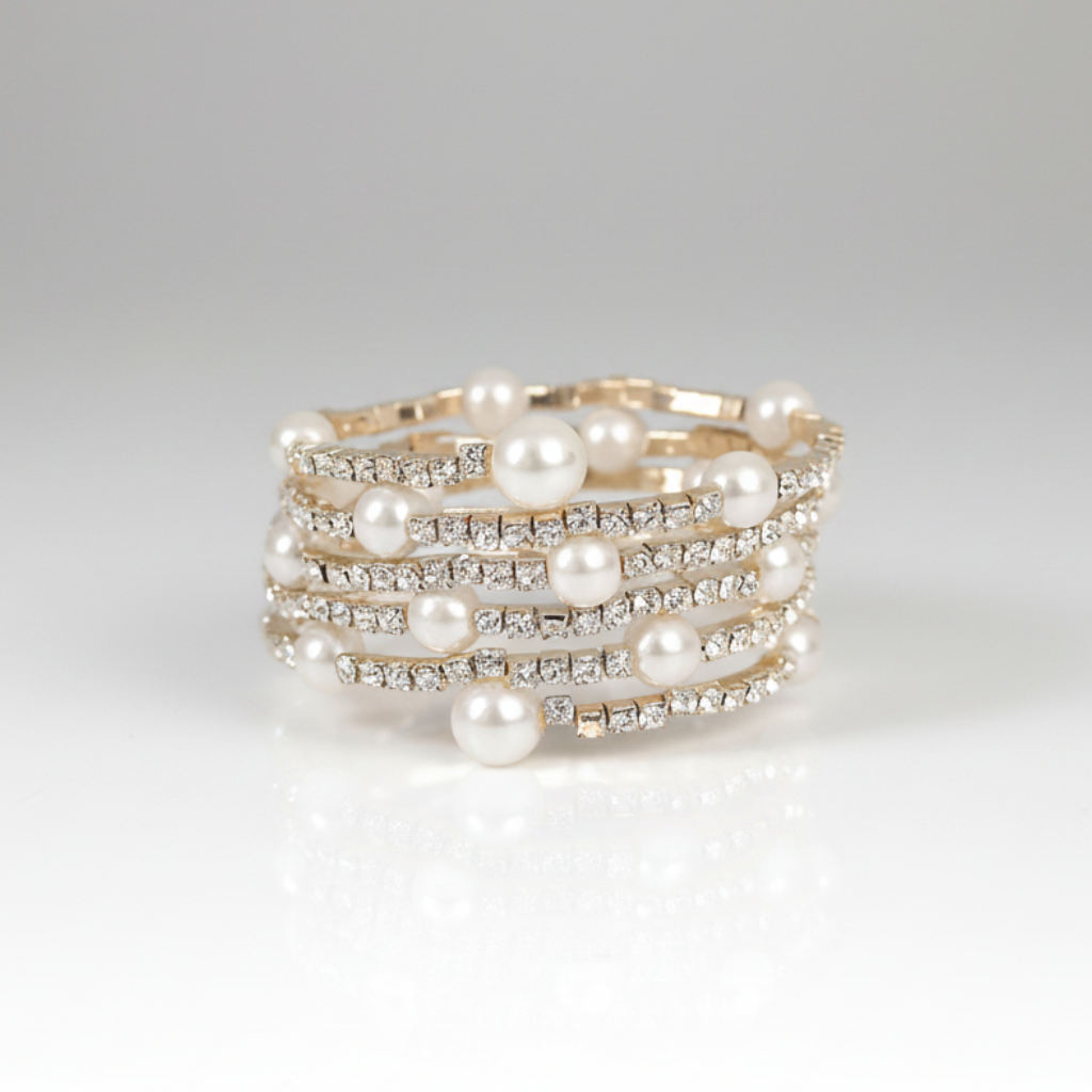 Multi-layered pearl and crystal ring on a light gray background