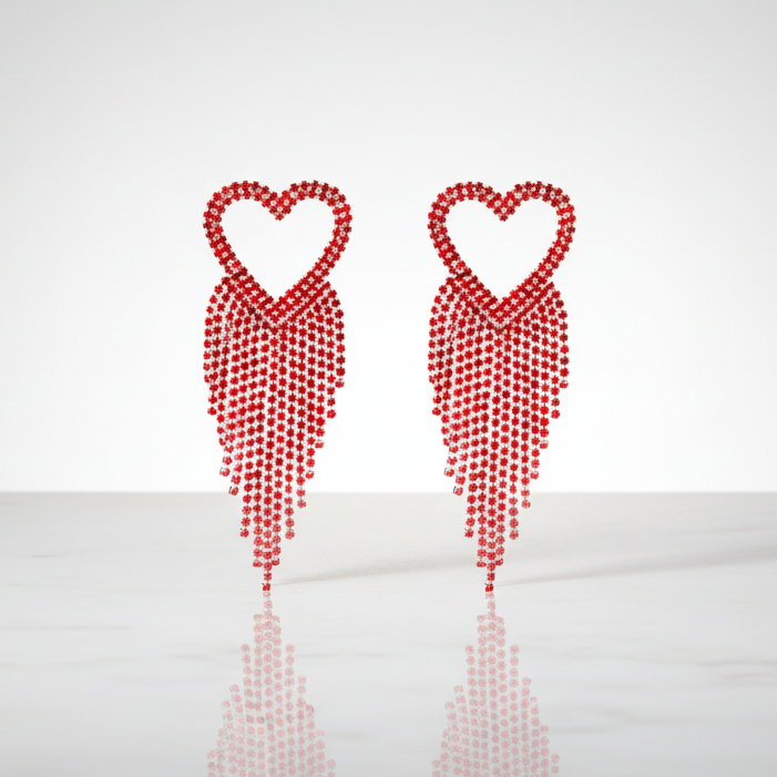Two red heart-shaped earrings on a white background