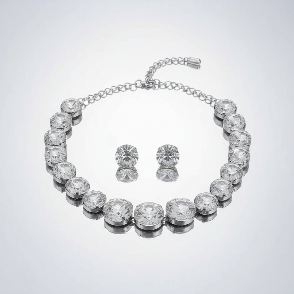 Silver jewelry set with necklace and earrings on a light gray background