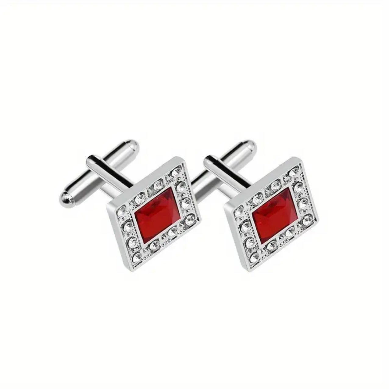 Silver cufflinks with red square stones on a white background