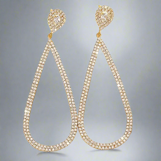 A pair of gold-colored, rhinestone-encrusted water drop dangle earrings on a grey background.