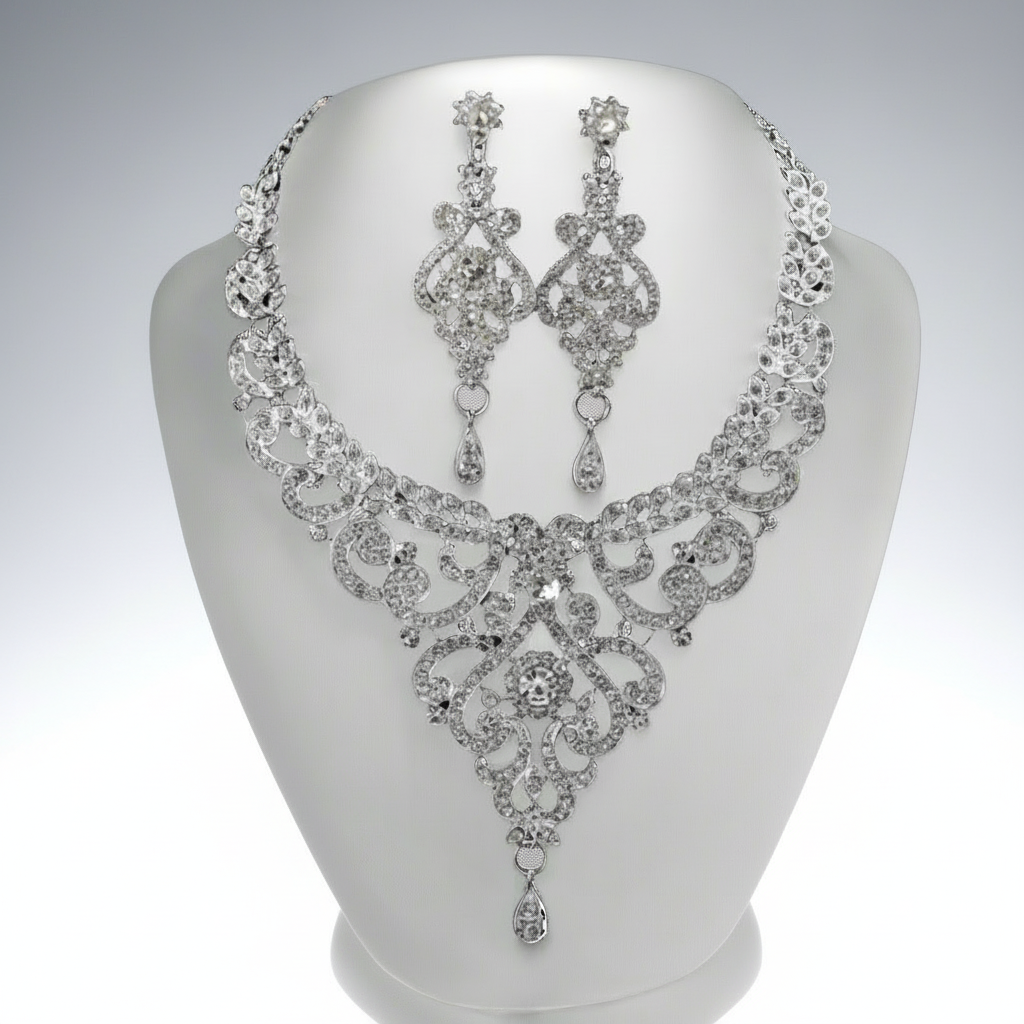 Silver necklace and earrings set on a mannequin bust against a white background