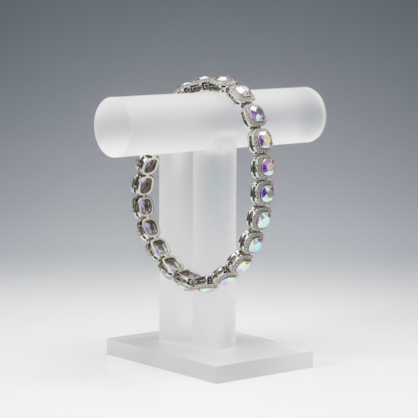 Bracelet on a white cylindrical stand against a gray background