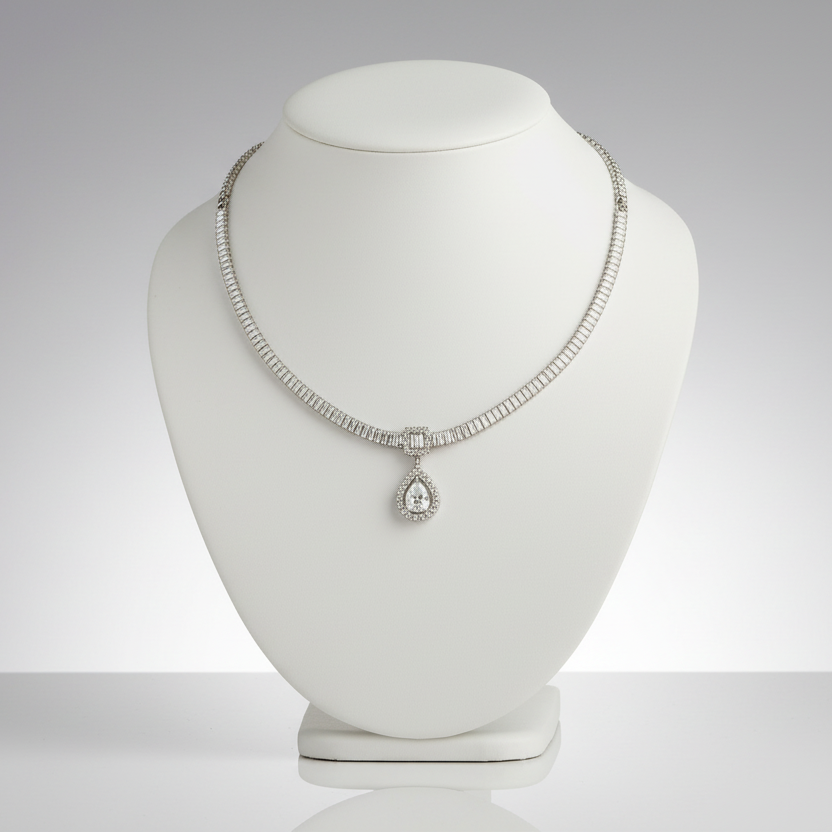Silver necklace with a pendant on a white mannequin bust against a gray background