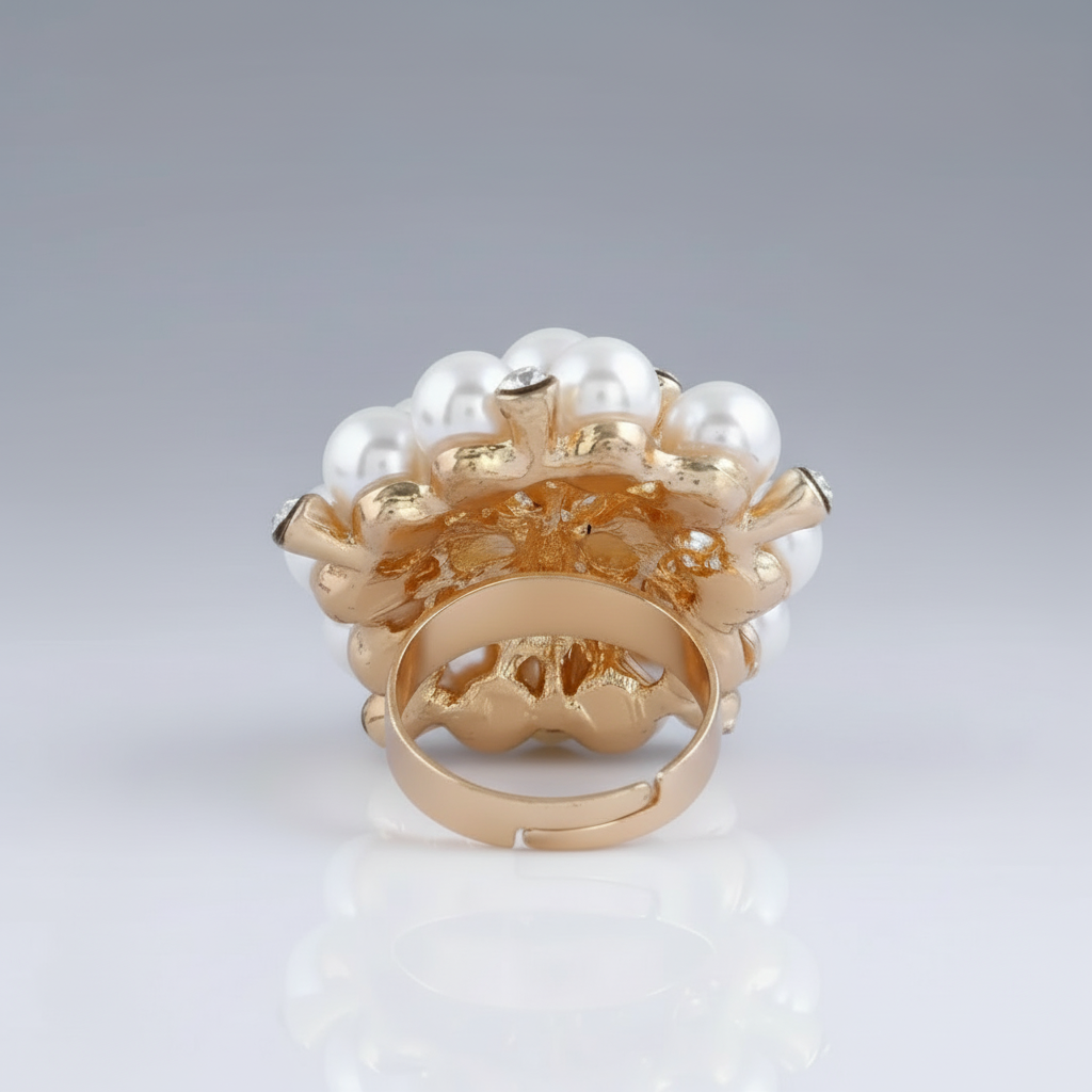Gold ring with pearls on a gray background