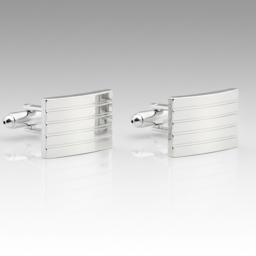 Pair of silver cufflinks on a light gray background