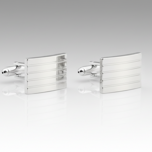 Pair of silver cufflinks on a light gray background