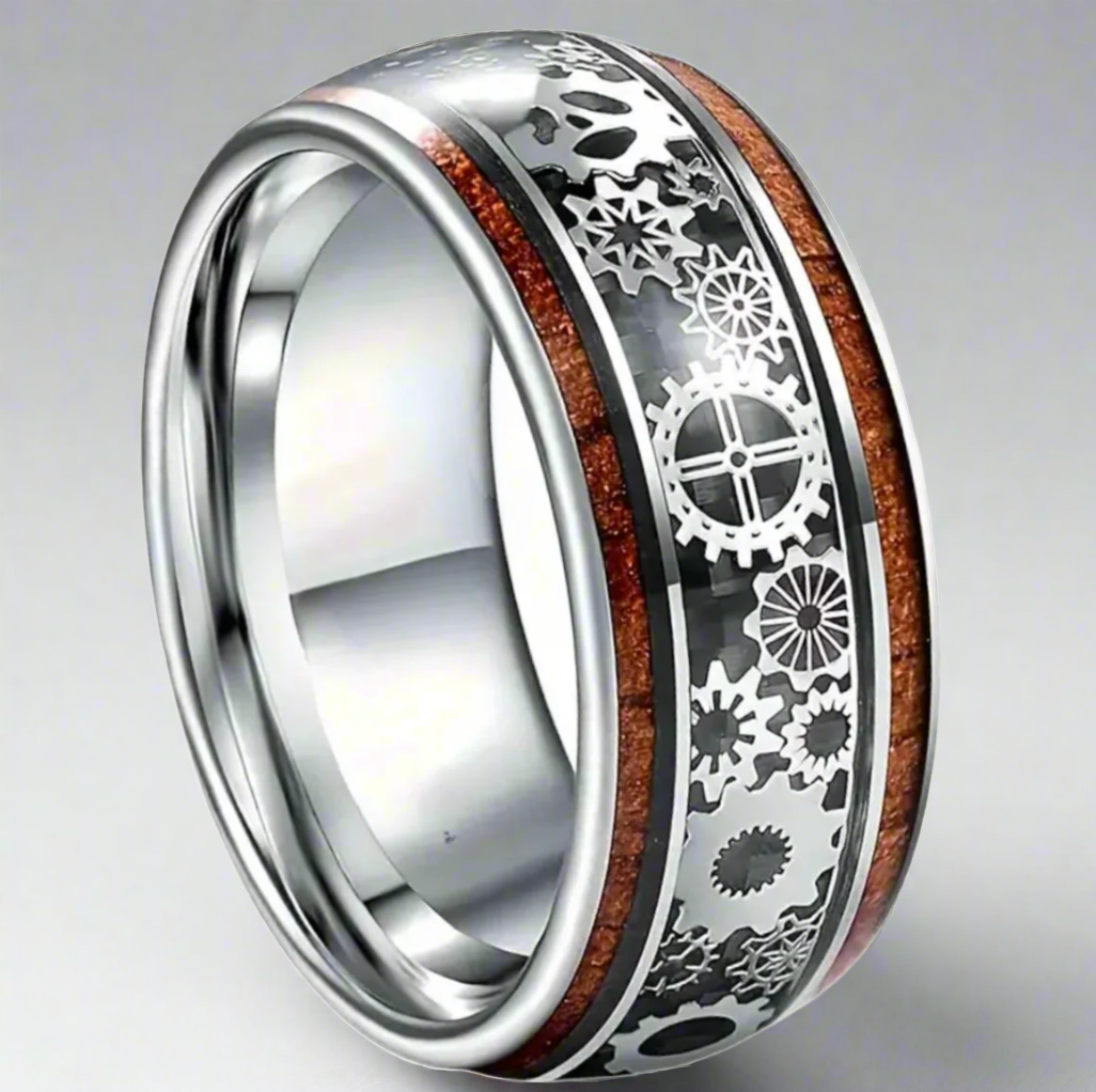 Silver ring with intricate design and wooden inlay on a white background