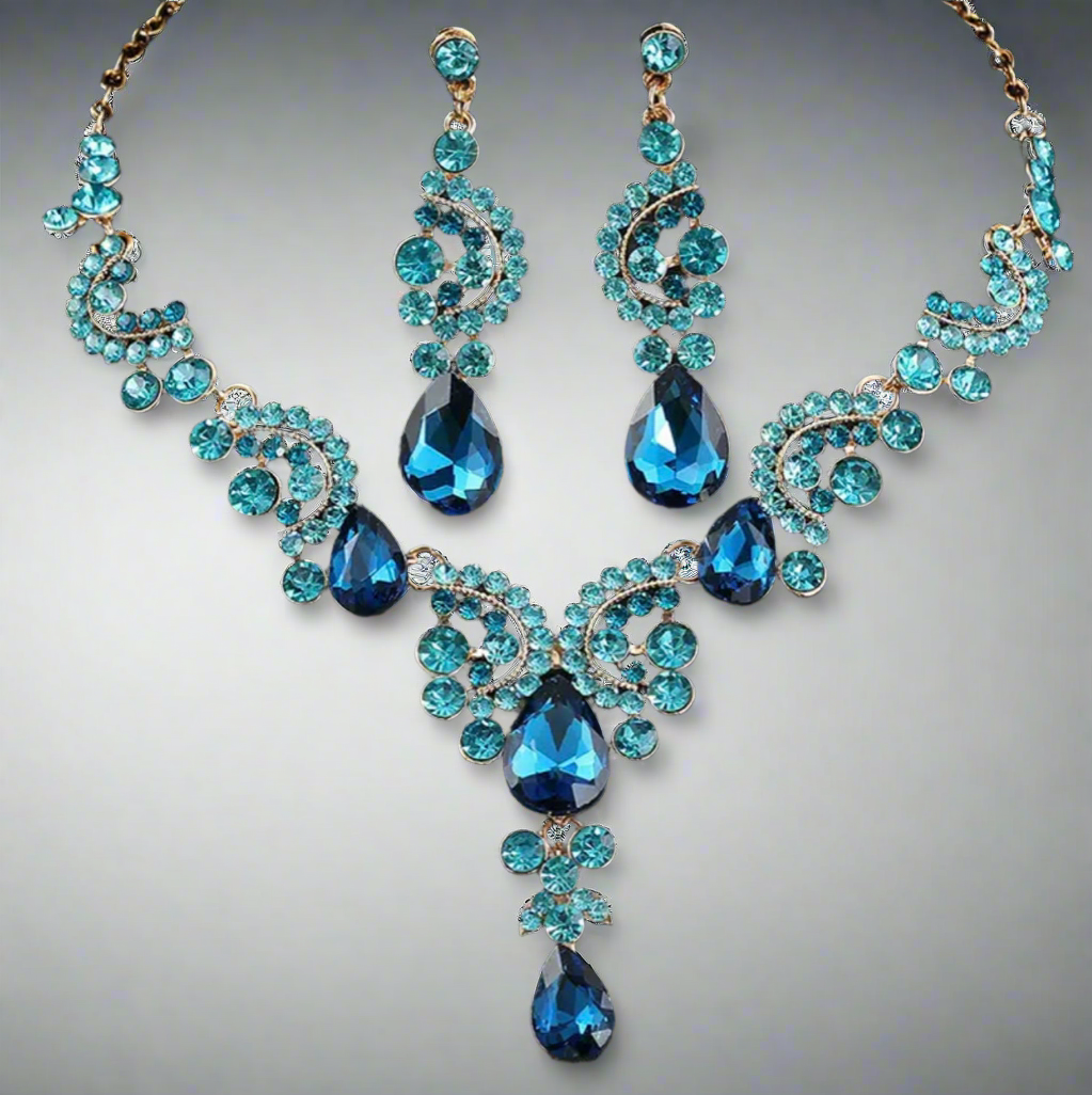 Blue gemstone necklace and earrings on a gray background