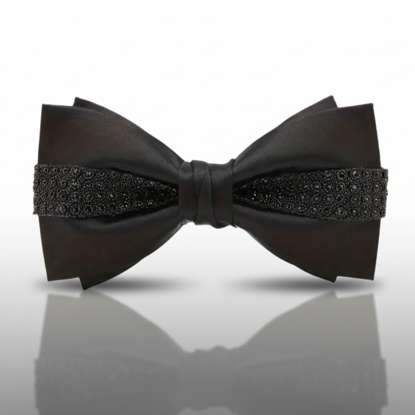 Black bow tie with decorative elements on a white background
