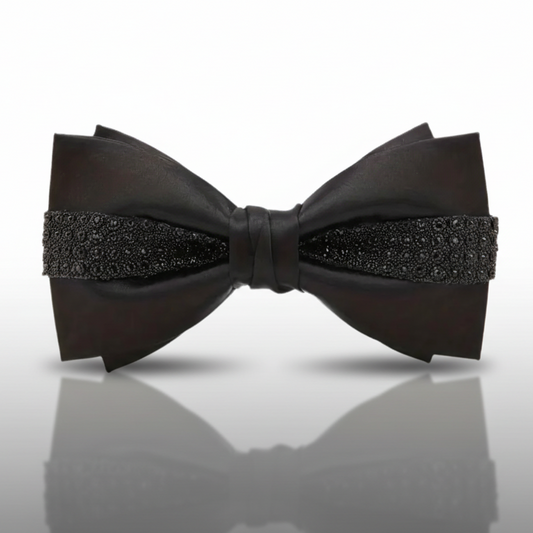 Black bow tie with decorative elements on a white background