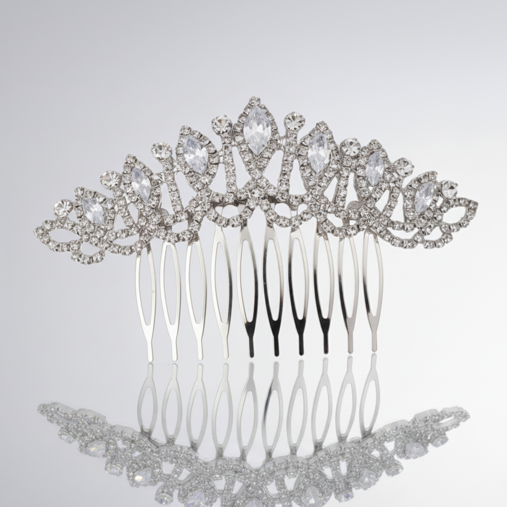 Silver hair comb with decorative elements on a light gray background