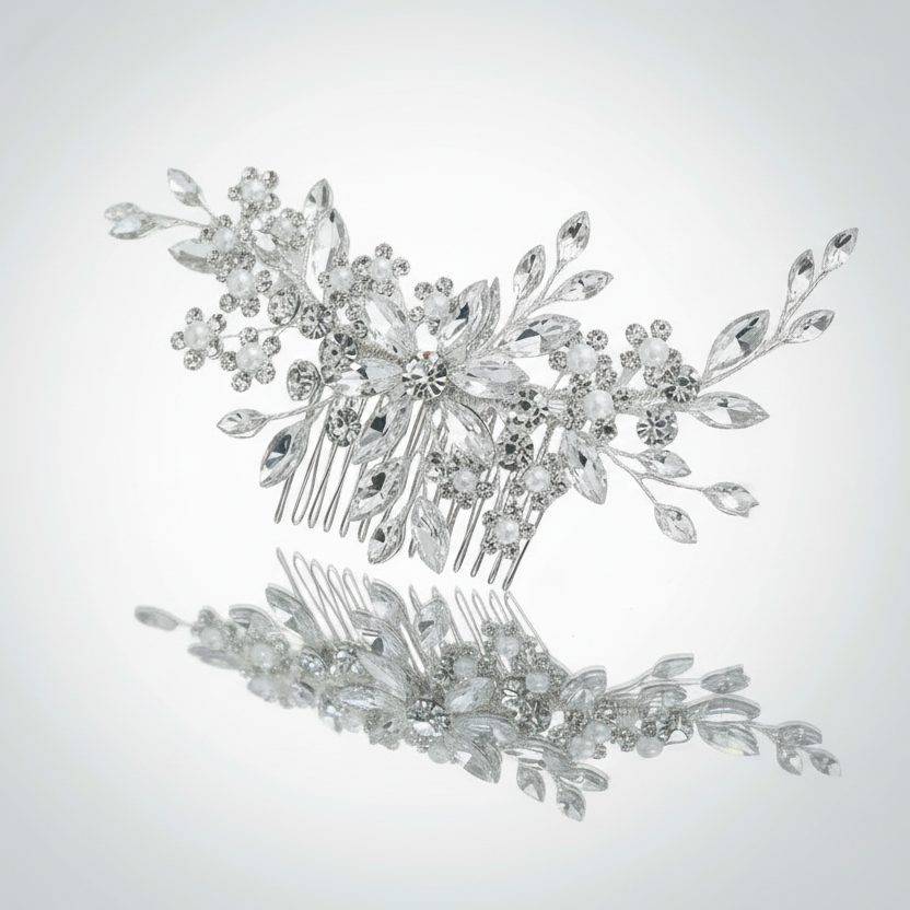 Silver hair comb with floral design on a light gray background