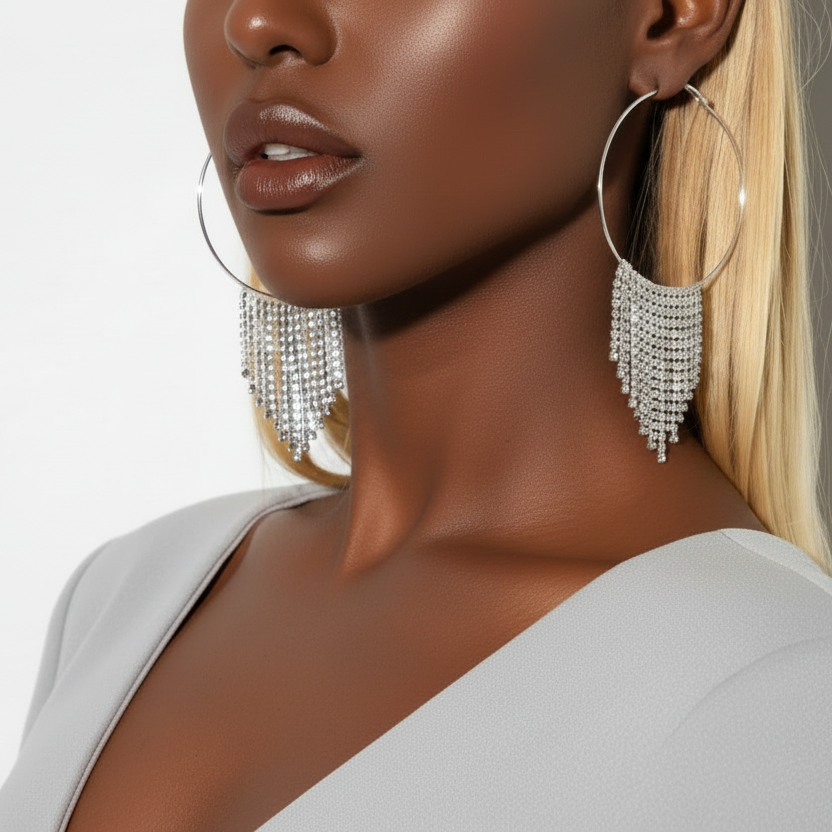 Woman wearing large hoop earrings with a neutral background