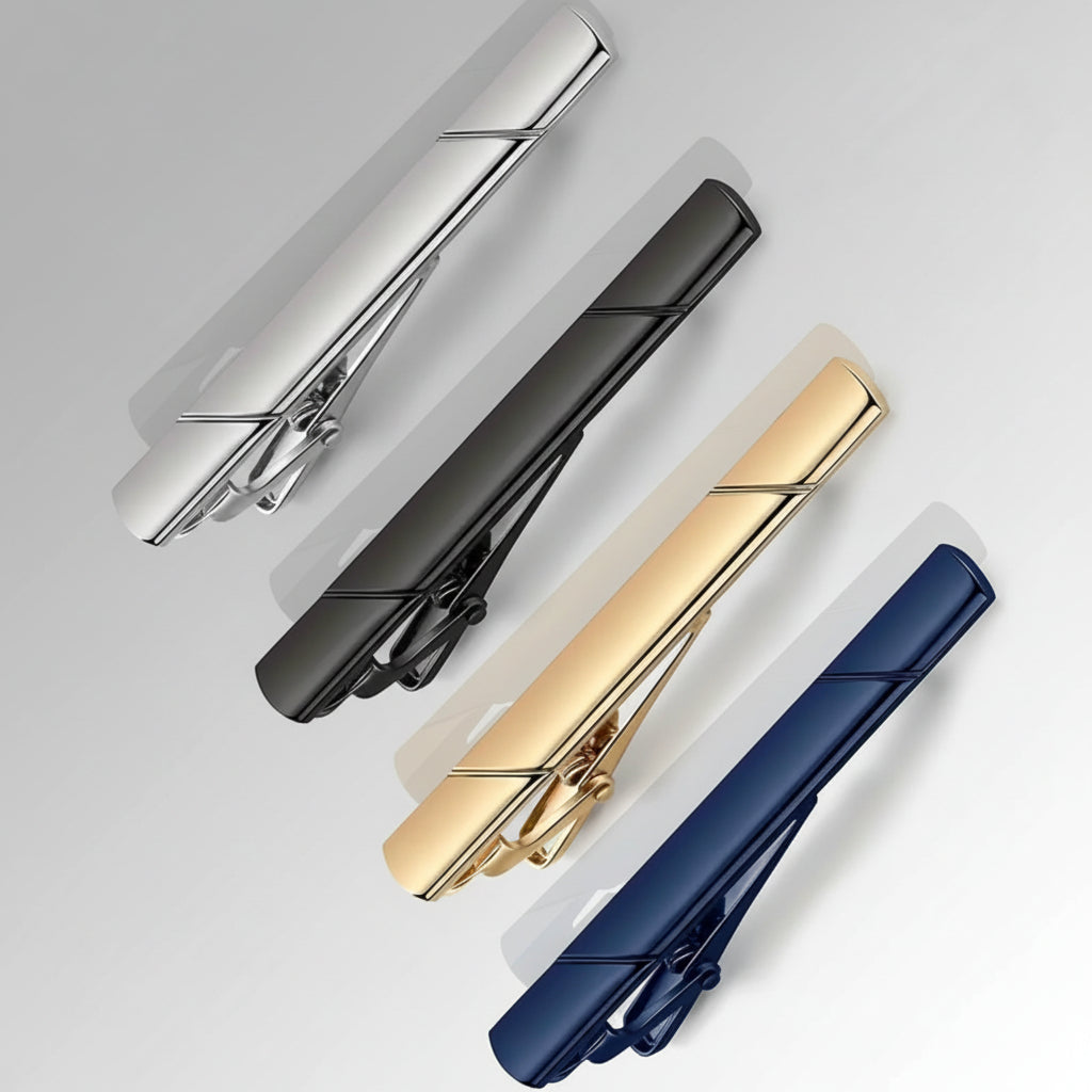 Set of four tie clips in gold, silver, black, and blue on a white background