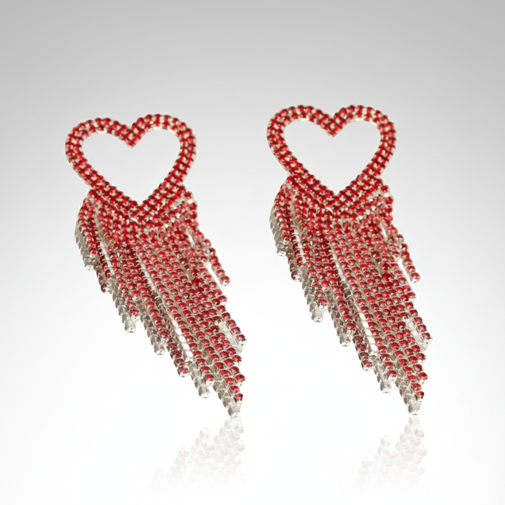 Heart-shaped earrings with red and clear beads on a white background