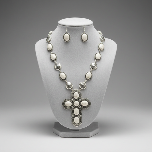 Jewelry set with necklace, earrings, and cross pendant on a gray background