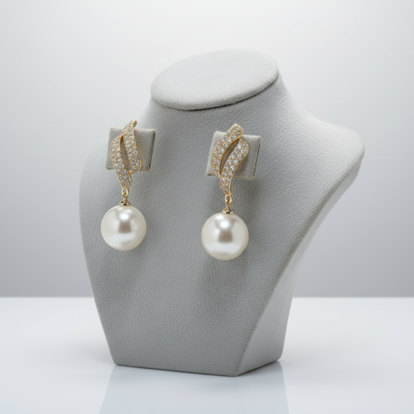 Pearl earrings on a gray jewelry display stand against a white background