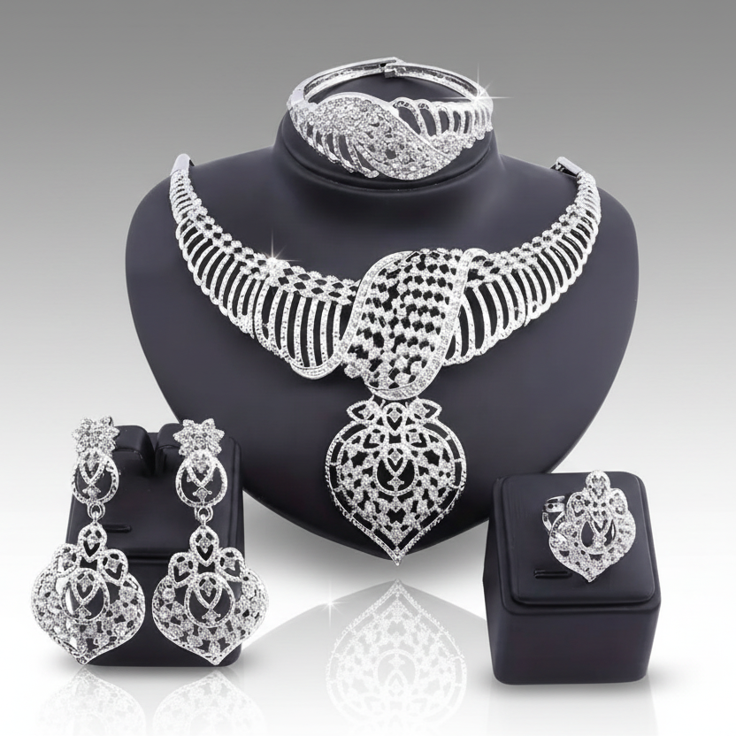 Silver jewelry set including necklace, earrings, and bracelet on a gray background