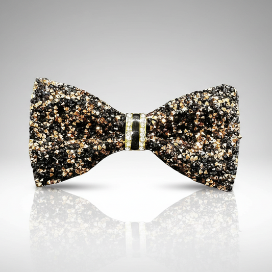 Glittering bow tie on a reflective surface with a gray background