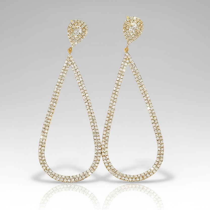 Teardrop-shaped earrings with clear gemstones on a gray background