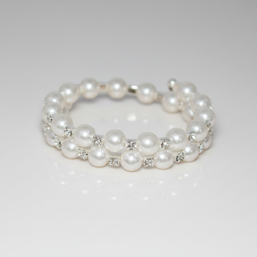 Pearl bracelet with small crystals on a light gray background