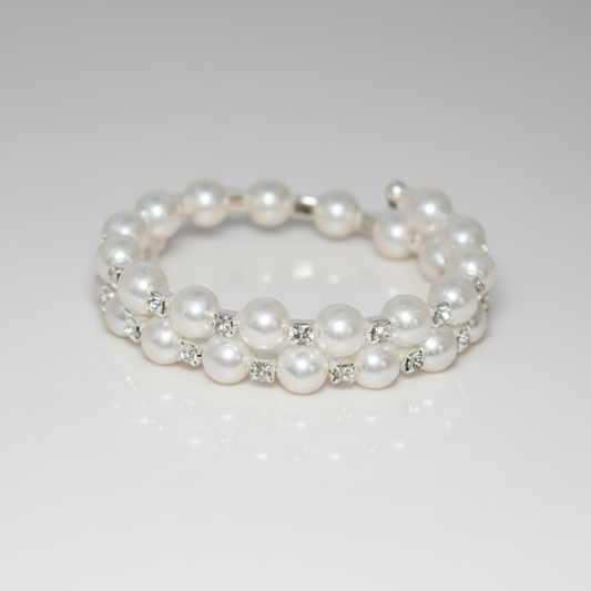 Pearl bracelet with small crystals on a light gray background