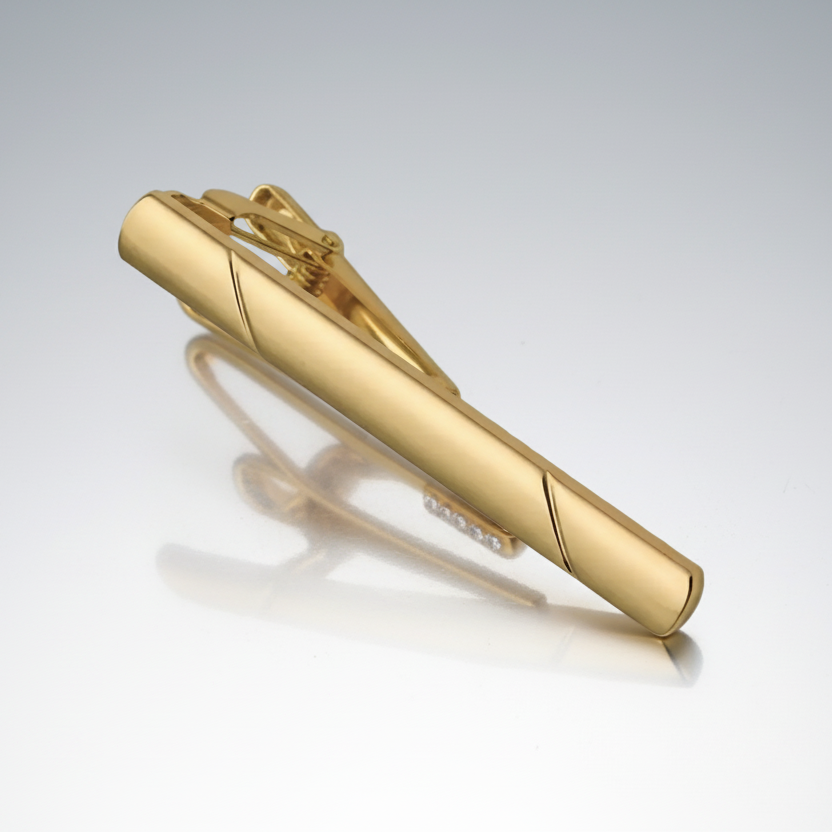 Gold tie clip on a white background
