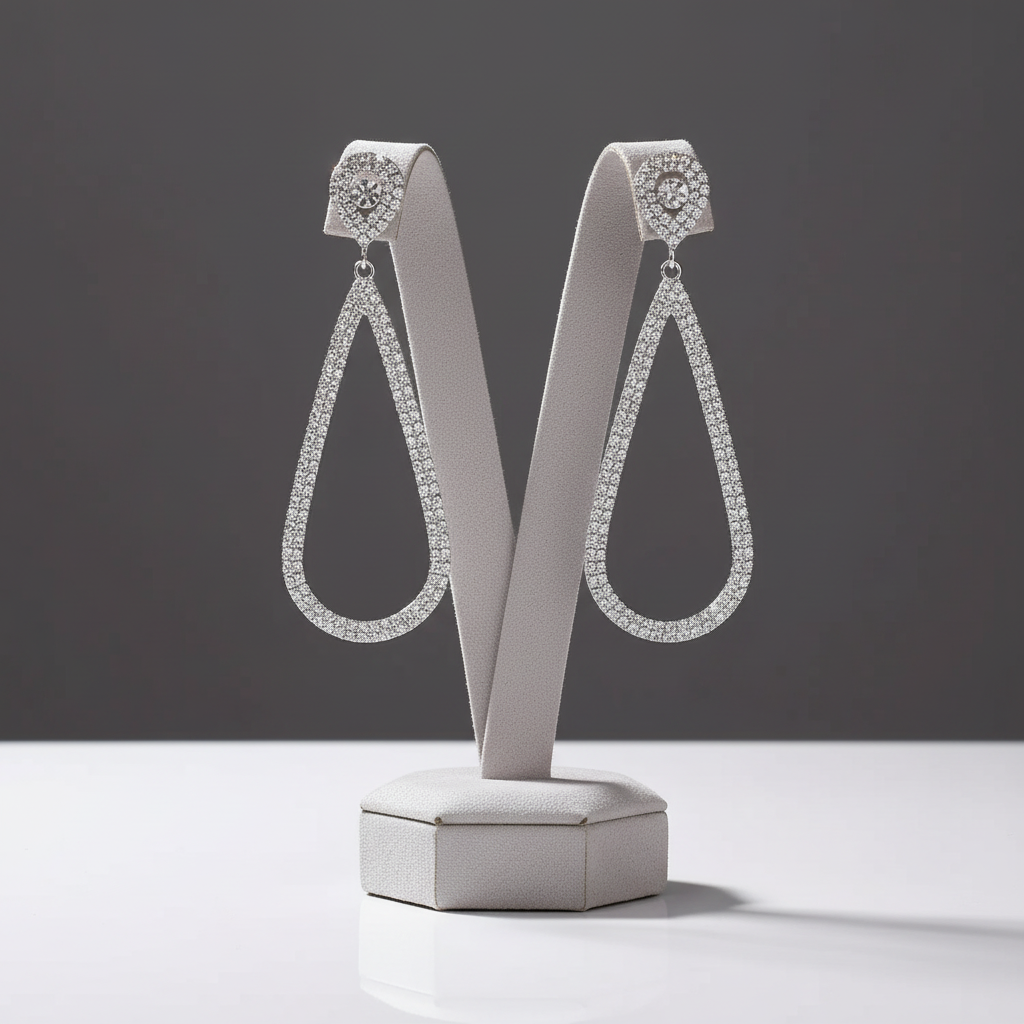 Pair of diamond earrings on a gray stand with a dark gray background