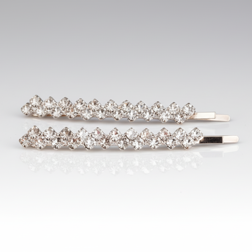 Two crystal hair pins on a light gray background