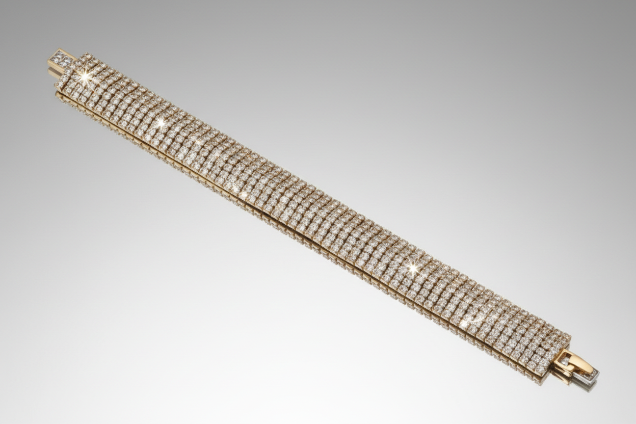 Gold bracelet with diamond accents on a gray background