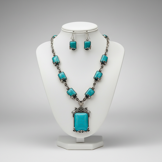 Turquoise necklace and earrings set on a white mannequin bust against a gray background