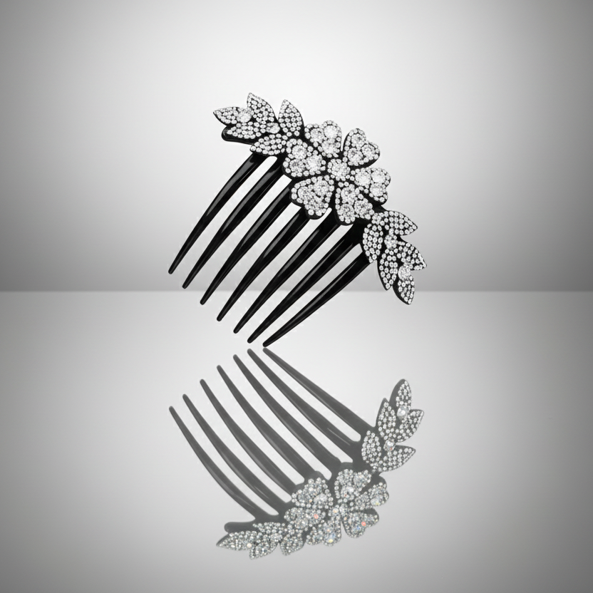 Decorative hair comb with floral embellishments on a reflective surface