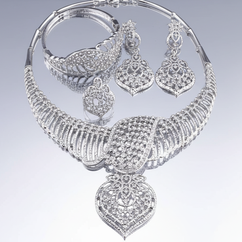 Silver jewelry set including necklace, earrings, and bangles on a light gray background