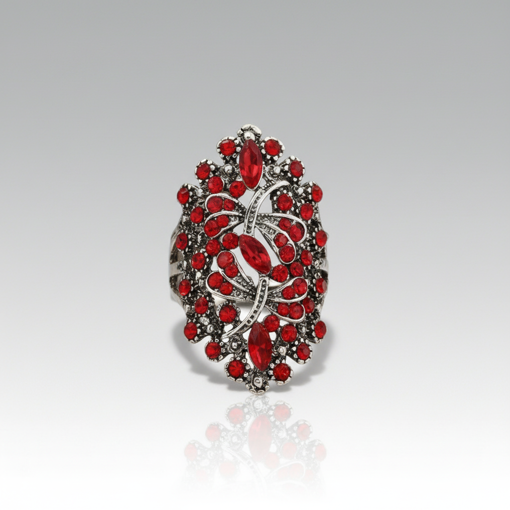 Decorative ring with red gemstones on a gray background