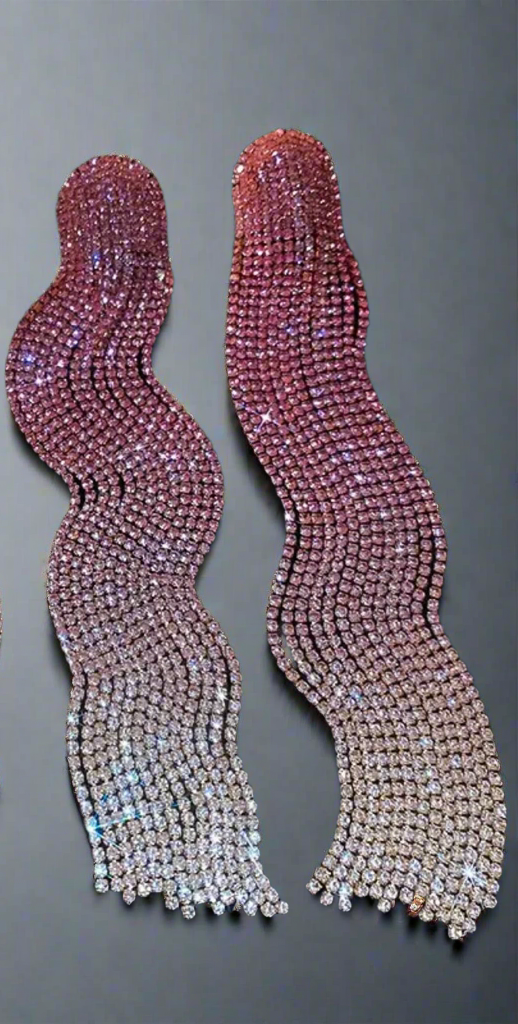 Pair of rhinestone earrings on a dark background