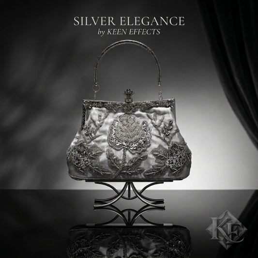 An ornate silver evening handbag with intricate floral embroidery and beadwork, displayed on a decorative stand against a dark gray and black background. Text at the top reads 'SILVER ELEGANCE by KEEN EFFECTS'.